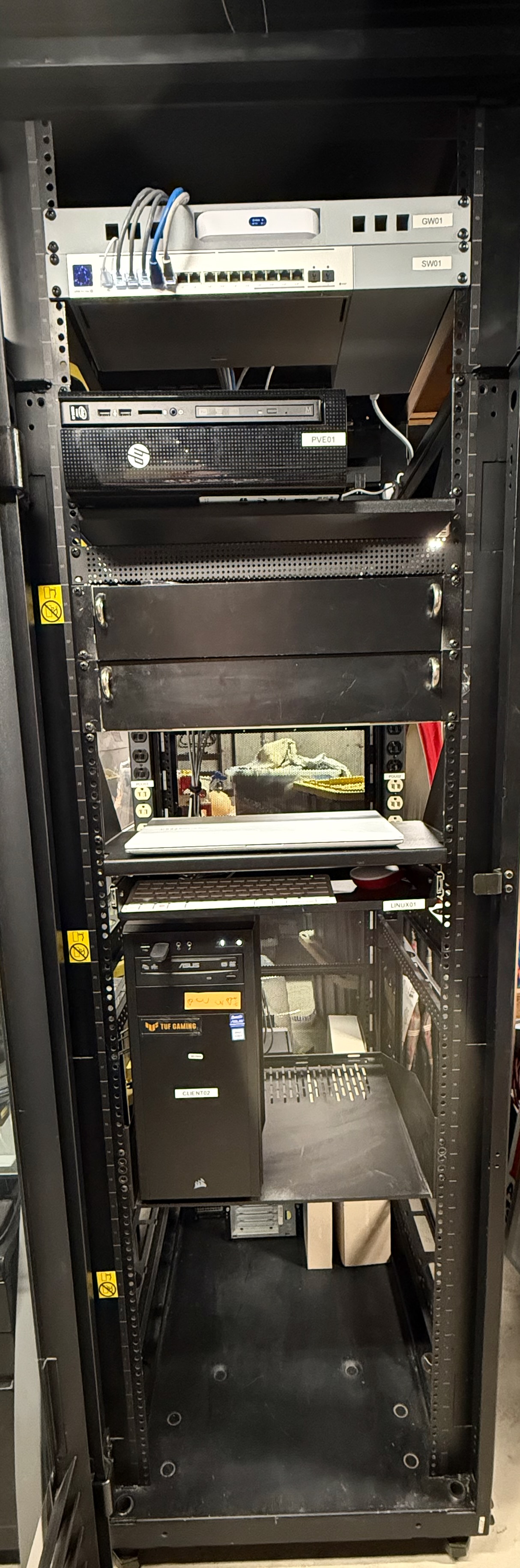 Rack-based enterprise home lab with labeled gateway, managed switch, Proxmox host, Linux system, and client workstation